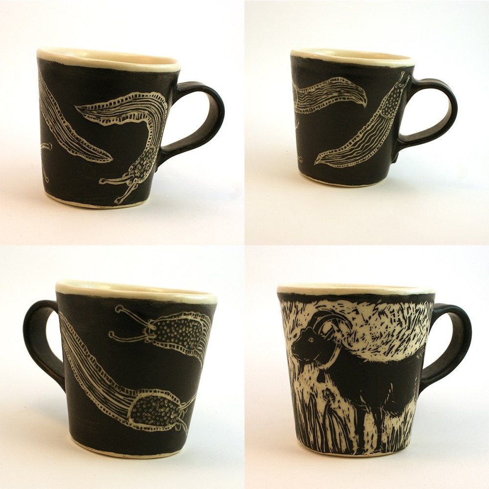 Four views of black sgraffito mugs, three showing banana slugs and leaves, one showing a long-haired goat in tall grass