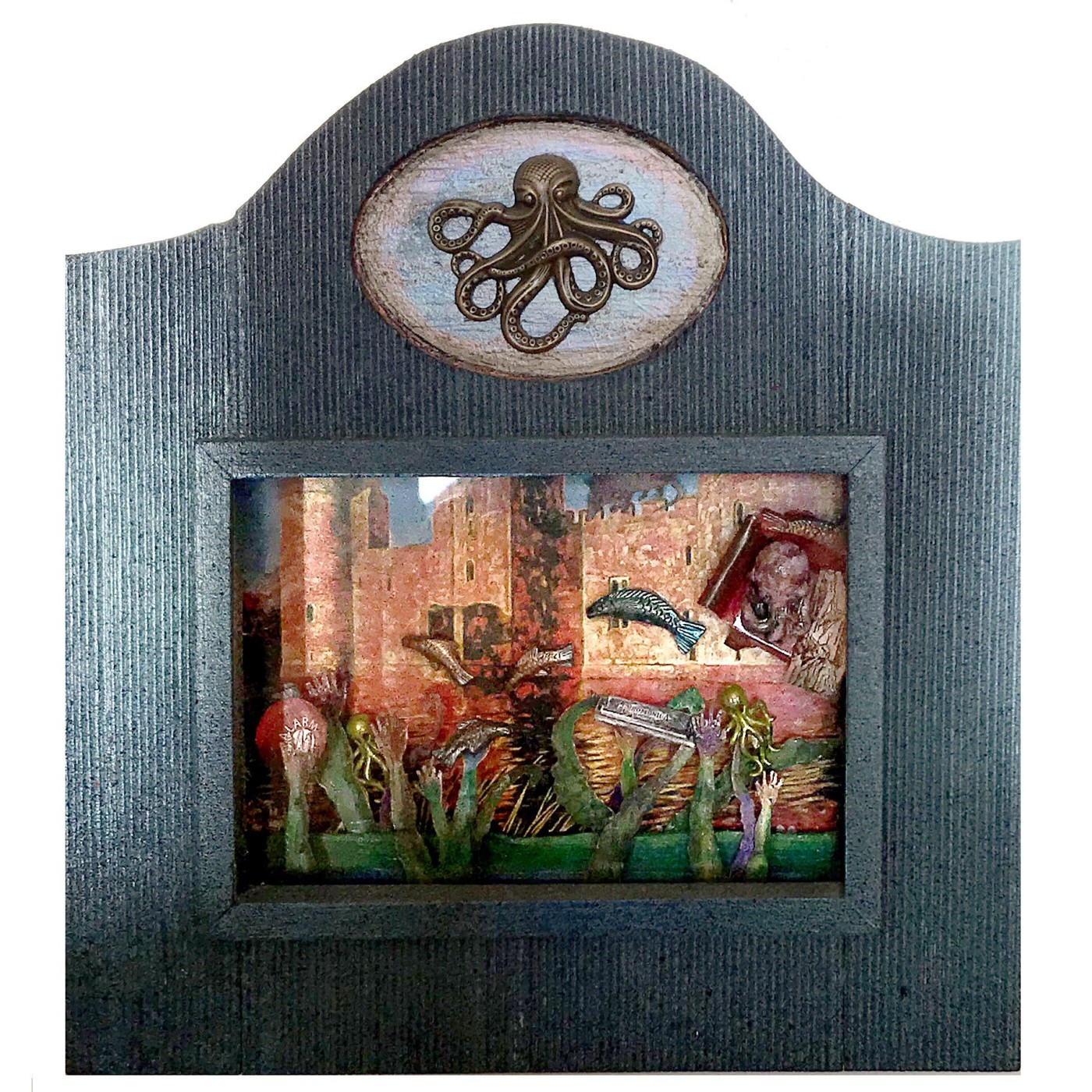 Arch-topped shadowbox in grey with a brass octopus medallion above a diorama of green tentacles and hands reaching up in front of a painted stone harbour wall