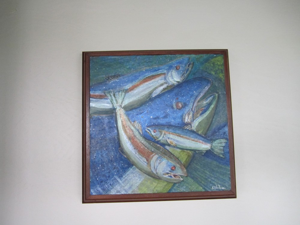 Four salmon painted in silver, blue and green against a deep blue ground flecked with white, in a dark wood frame