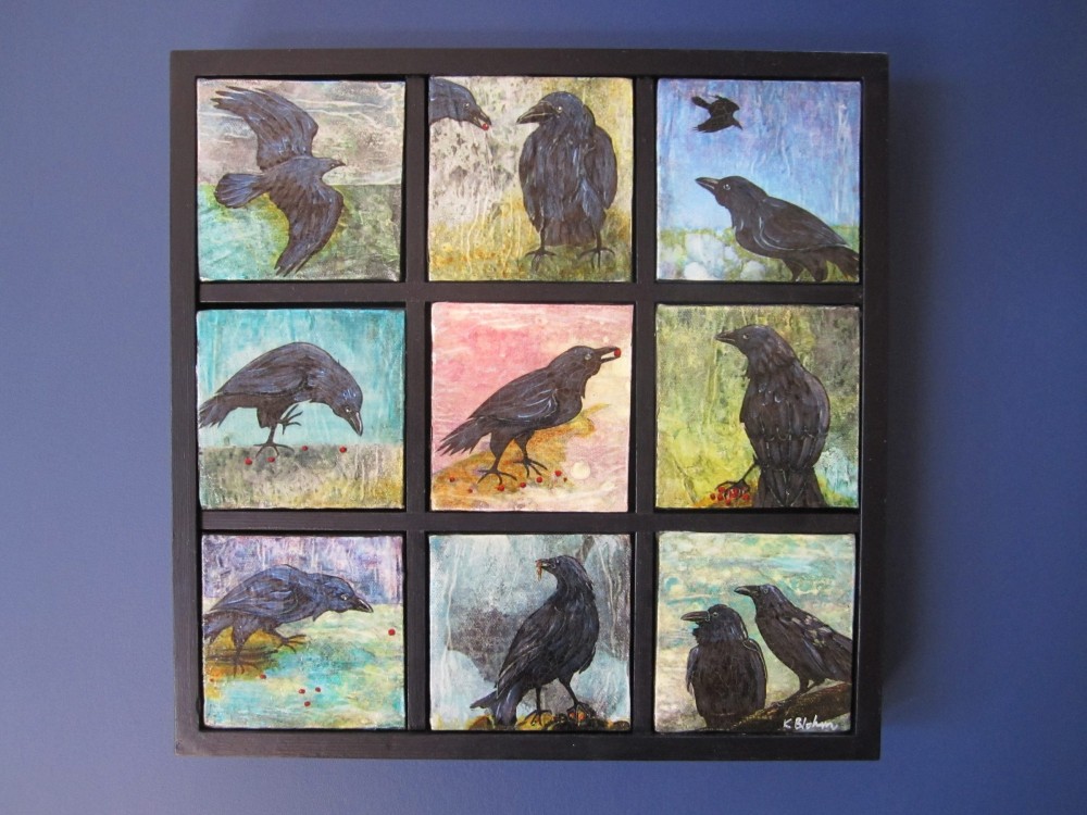 Nine small square paintings of crows set in a black grid frame, each bird on a differently coloured washy ground, several pecking at red berries