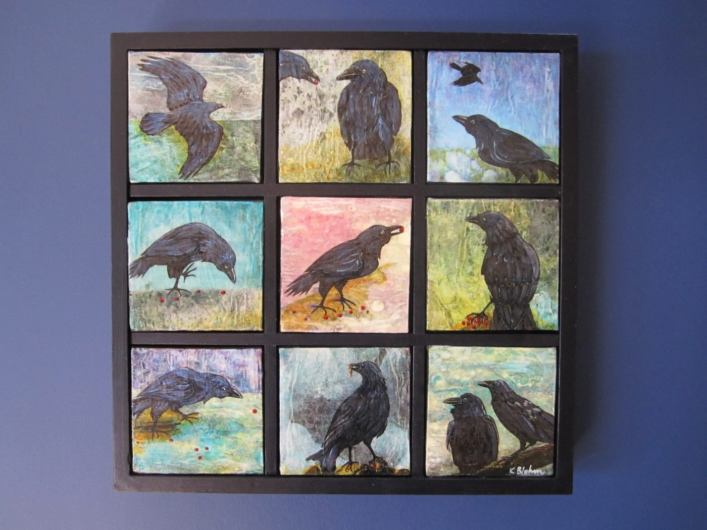 Nine small square paintings of crows set in a black grid frame, each bird on a differently coloured washy ground, several pecking at red berries