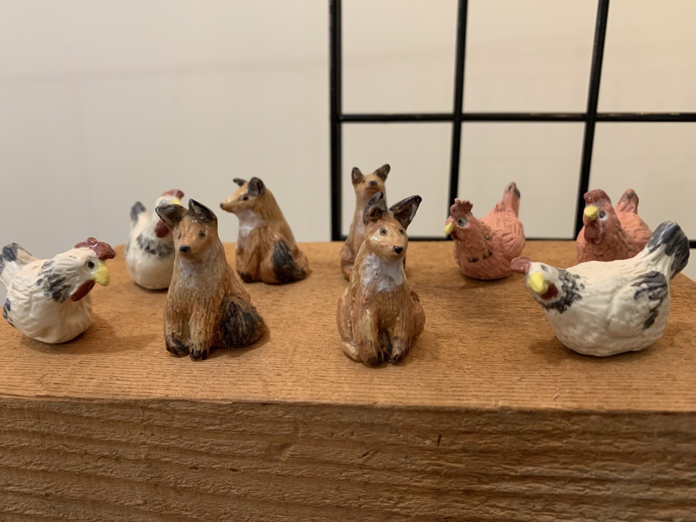 Part of small clay checker set pieces  — speckled hens and seated red foxes